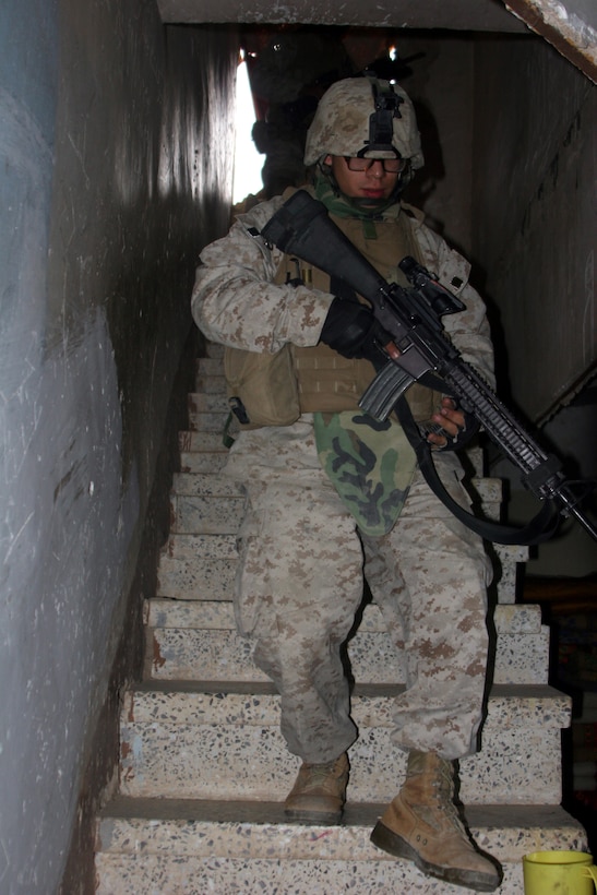 AR RAMADI, Iraq (November 20, 2005) - A Marine with Company I, 3rd Battalion, 7th Marine Regiment clears a house during Operation Machete Nov. 20. The Marines of 3/7 and 1st Combat Engineers Battalion discovered the largest weapons cache in more than six months during the mission. Photo by Cpl. Shane Suzuki