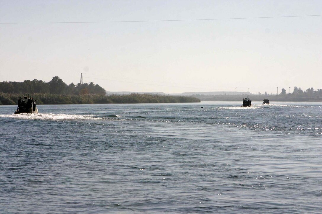HADITHA DAM, Iraq (Dec. 9, 2005) - Boats from the Dam Security Unit here patrol the waters of the Euphrates River looking for insurgent activity Dec. 9. The unit, currently attached to 3rd Battalion, 1st Marine Regiment, keeps the waters around the dam safe for the thousands of Iraqi people who depend on the dam's operation to get their power. (Official Marine Corps photo by Cpl. Adam C. Schnell)