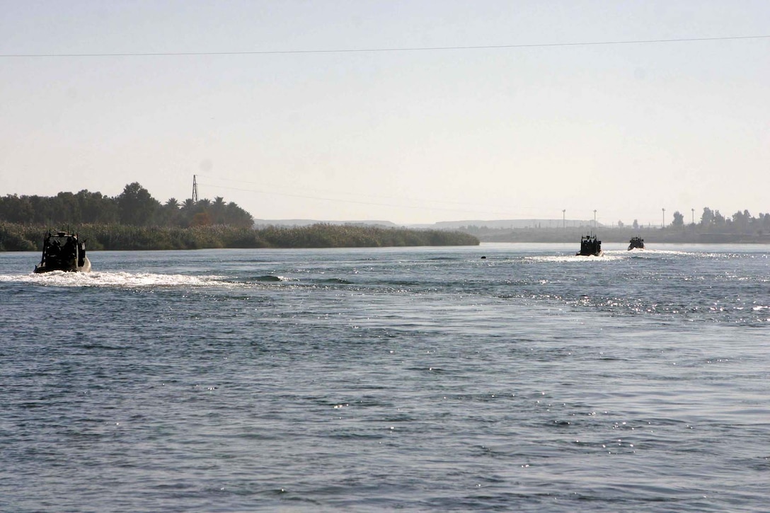 HADITHA DAM, Iraq (Dec. 9, 2005) - Boats from the Dam Security Unit here patrol the waters of the Euphrates River looking for insurgent activity Dec. 9. The unit, currently attached to 3rd Battalion, 1st Marine Regiment, keeps the waters around the dam safe for the thousands of Iraqi people who depend on the dam's operation to get their power. (Official Marine Corps photo by Cpl. Adam C. Schnell)