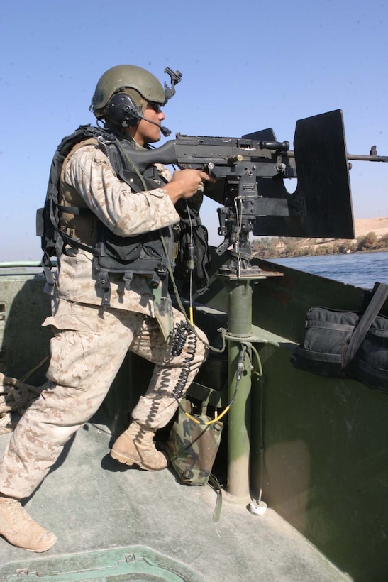 HADITHA DAM, Iraq (Dec. 9, 2005) -Lance Cpl. Jose N. Loya, an Amarillo, Texas native and bow gunner for the Dam Security Unit, operates the M-240G machine gun during a patrol Dec. 9. The unit, currently attached to 3rd Battalion, 1st Marine Regiment, is made up of mainly reservists who saw being part of a boat unit a great opportunity. (Official Marine Corps photo by Cpl. Adam C. Schnell)