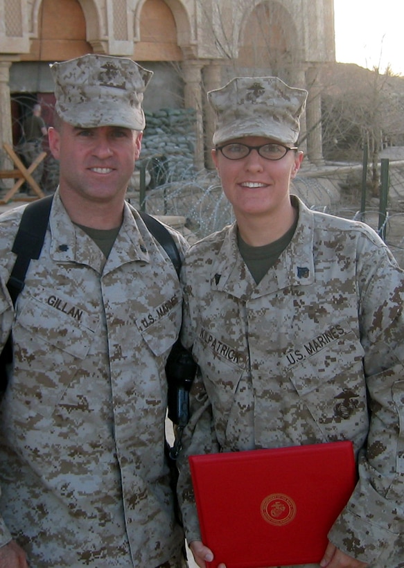 CAMP BLUE DIAMOND, AR RAMADI, Iraq -- Corporal Melissa Kilpatrick, an intelligence analyst with the 2nd Marine Division, poses with her boss LtCol. Andrew Gillan, for a photo with her newly awarded Navy and Marine Corps Achievement Medal certificate for her work in Operation Iraqi Freedom.