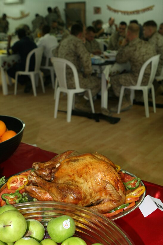 CAMP RIPPER, Iraq ?A turkey on display as Marines share a Thanksgiving meal in the background at a chow hall here Nov. 24.  Marines assigned to Regimental Combat Team 2, 2nd Marine Division, reflected today on their teammates, their fallen comrades and gave thanks for the closer bonds forged amongst themselves during recent combat operations here.