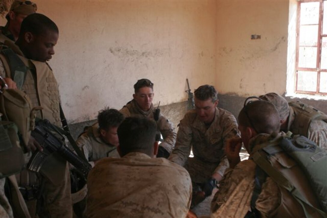 KARABILAH, Iraq ? (pictured center) Second Lt. Erik R. Sallee, 24, of Oklahoma City, and platoon commander for 3rd Platoon, Company E, 2nd Battalion, 1st Marine Regiment, gives a brief to the small unit leaders of his platoon at a safe house here, Nov. 9. Despite being slightly wounded the day prior, Sallee continued leading his Marines during Operation Steel Curtain against insurgents within border towns on the Lower Euphrates River Valley.
