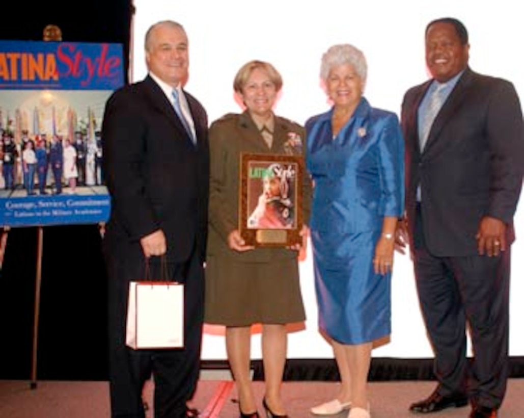 From left to right, Robert E. Bard, President and CEO, Latina Style, Marine Col. Angie Salinas, Chief of Staff, Marine Corps Recruiting Command, Quantico, Va., congresswoman Grace Napolitano, and Clarence A. Johnson, Principal Director, Office of the Deputy Under Secretary of Defense for Equal Opportunity, pose after presenting Salinas with an award for her accomplishments and contributions to her country.
