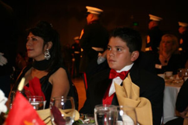 April and Nicholas Popaditch listen as Gunnery Sgt. Nick Popaditch speaks to guests at the MCAGCC Birthday Ball Nov. 9.  Popaditch was medically retired earlier this year because of wounds received in combat last year in Iraq.