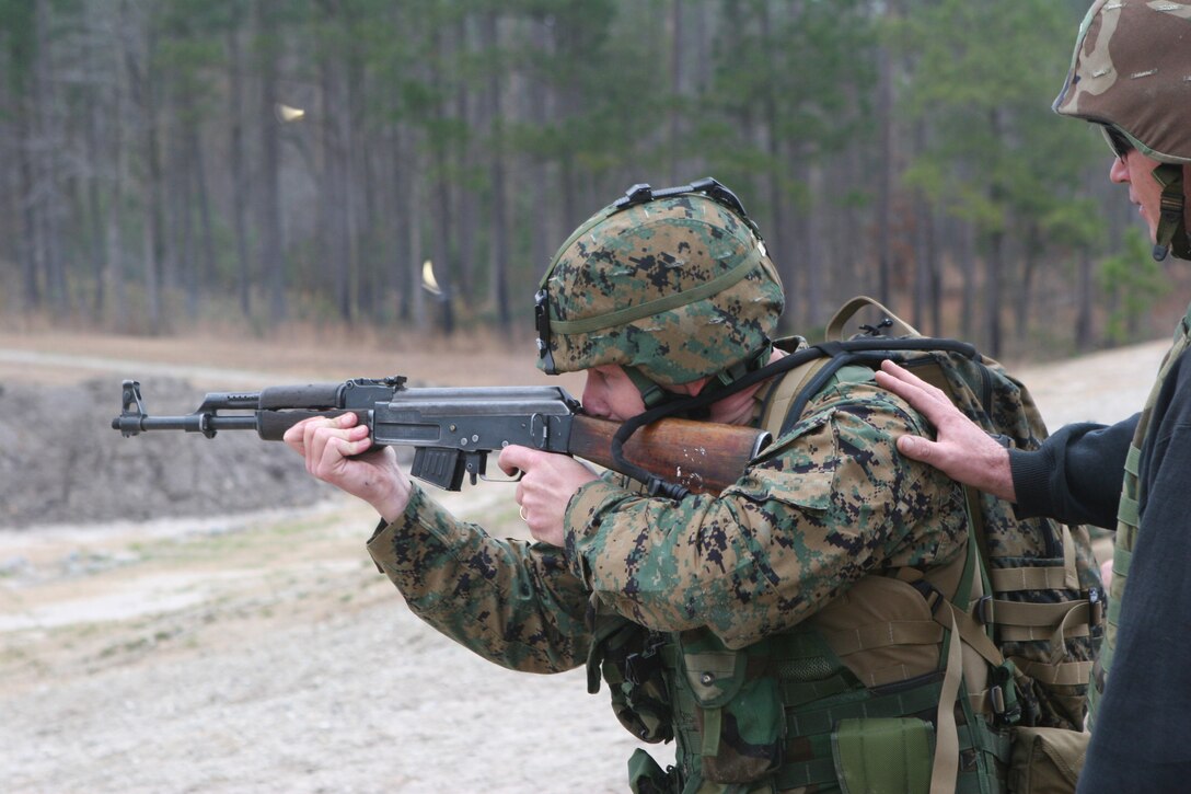 Maj. Kevin M. Corcoran, who will be augmenting 2nd Marine Division operations, as assistant plans officer, fires the AK-47 assault rifle Jan. 7, as part of training held for Reserve Marines deploying to Iraq.