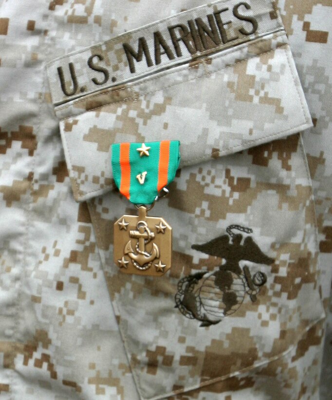 A Navy Achievement Medal hangs off the breast pocket of a Marine with 2d Battalion, 2d Marine Regiment during an awards ceremony recently.