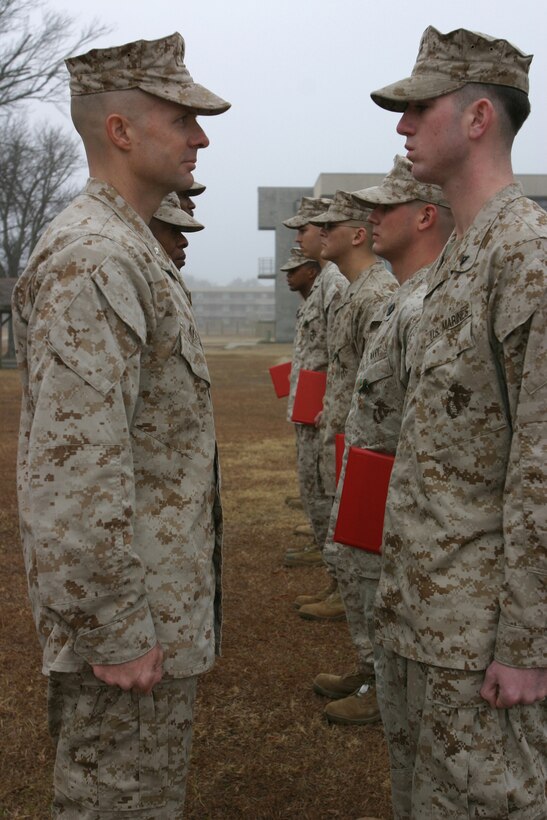 Lieutenant Col. James Kyser, commanding officer for 2d Battalion, 2d Marine Regiment (Left) stands in front of Lance Cpl. Robert Johnson, a Dunn, N.C. native and mortar man for the battalion, before Johnson was awarded the Navy and Marine Corps Achievement medal with a combat distinguishing device recently. Johnson, and 14 other service members received combat awards for their actions while in supporting Operation Iraqi Freedom. (Official Marine Corps photo by Cpl. Adam C. Schnell)