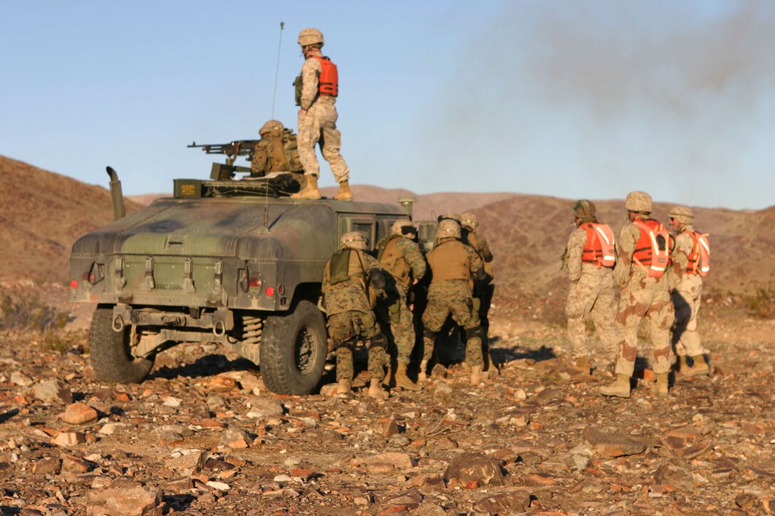 050111-M-4224F-001 29 PALMS, Calif.- Marines with 3rd Battalion, 2d Marine Regiment prepare to rush a fighting hole during the Hasty Squad Attack and Live Grenade Range. The range taught the Marines the importance of working as a team to take an enemy down. This training was the last chance for these Marines to prepare for deployment to Iraq. U.S. Marine Corps photo by Lance Cpl. Lucian Friel (RELEASED)