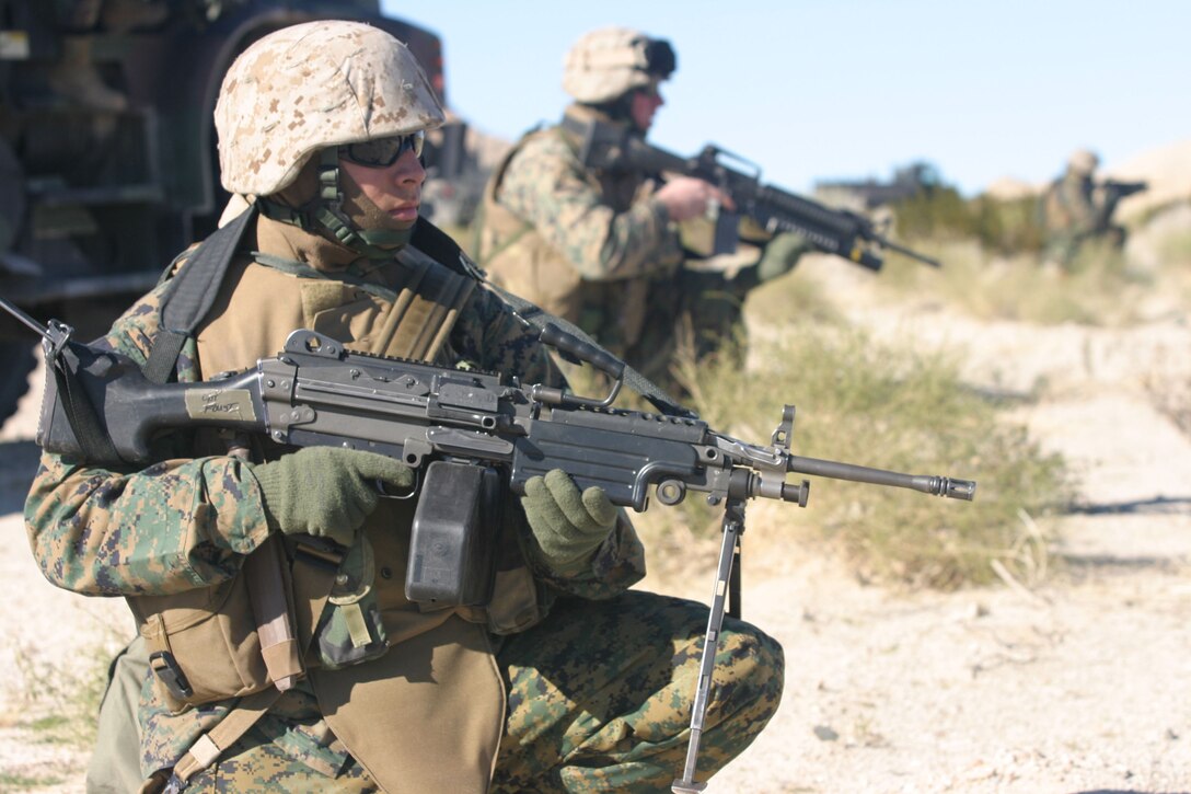 050112-M-4224F-001 29 PALMS, Calif.- Private First Class Edward Diaz, a native of Fresno, Calif., scans the area for a possible enemy threat during convoy operations training. The motor transport operator with 3rd Battalion, 2d Marine Regiment graduated from Sierra High School in 2002. U.S. Marine Corps photo by Lance Cpl. Lucian Friel (RELEASED)