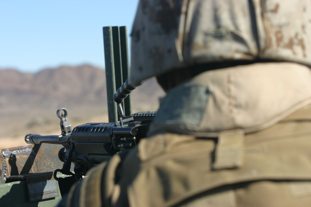 050112-M-4224F-002 29 PALMS, Calif.- Scanning the terrain of southern California, Pfc. Edward Diaz is prepared to fire on any enemy that threatens his convoy during convoy operations training. The training was the last opportunity for Marines to prepare for what they'll face in Iraq. The motor transport operator graduated from Sierra High School in 2002. U.S. Marine Corps photo by Lance Cpl. Lucian Friel (RELEASED)
