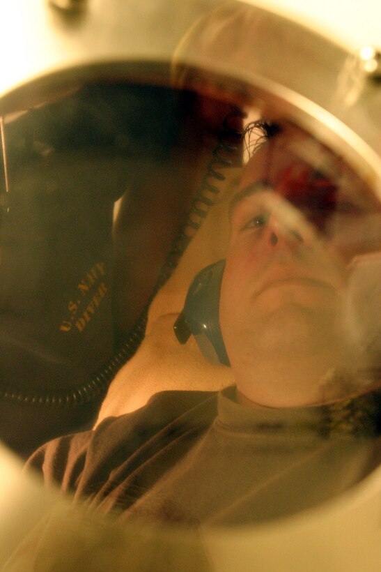 Sergeant Charles J. Rhinehart listens to music while in a hyperbaric recompression chamber system at 2d Reconnaissance Battalion, Feb. 10.  Rhinehart in undergoing special therapy using the chamber to heal wounds he received from an improvised explosive device he encountered last summer in Iraq.  USMC Photo by Sgt. Stephen D'Alessio (RELEASED) dalessiosk@2mardiv.usmc.mil