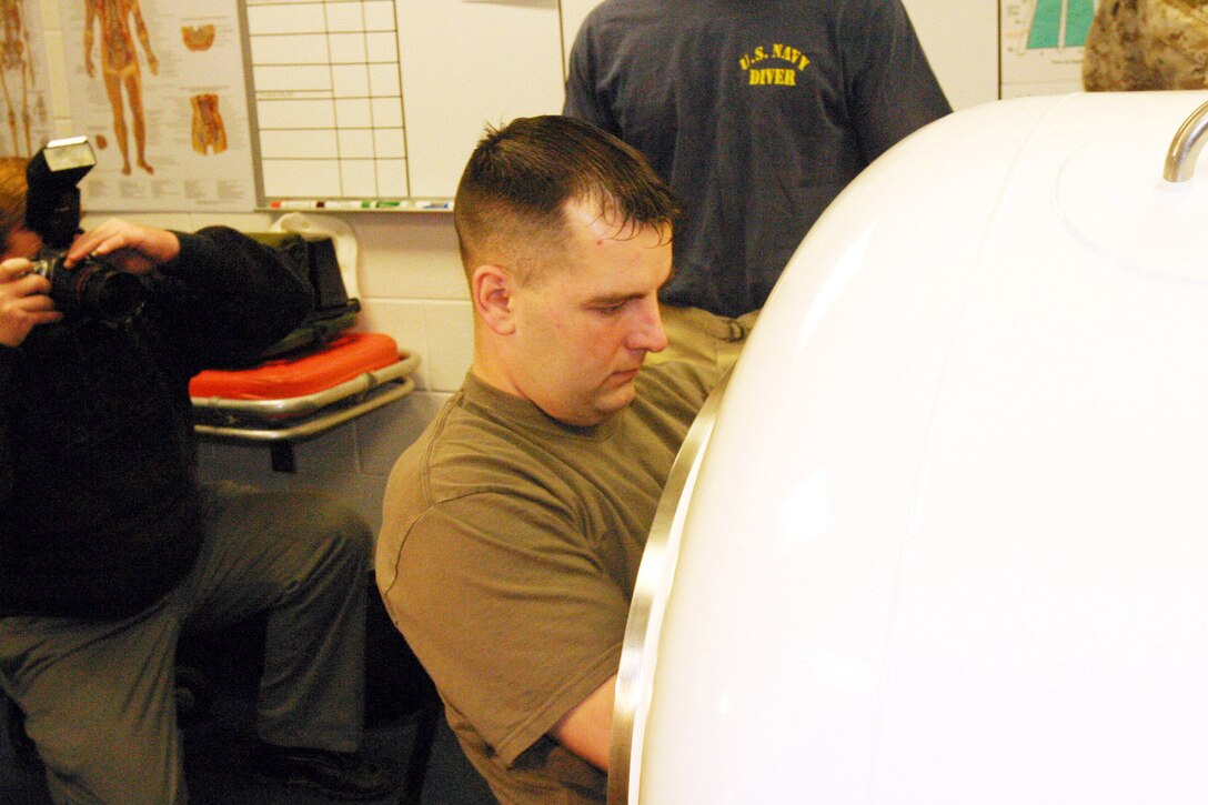Sergeant Charles J. Rhinehart enters a hyperbaric recompression chamber system at 2d Reconnaissance Battalion, Feb. 10.  Rhinehart in undergoing special therapy using the chamber to heal wounds he received from an improvised explosive device he encountered last summer in Iraq.  USMC Photo by Sgt. Stephen D'Alessio (RELEASED) dalessiosk@2mardiv.usmc.mil