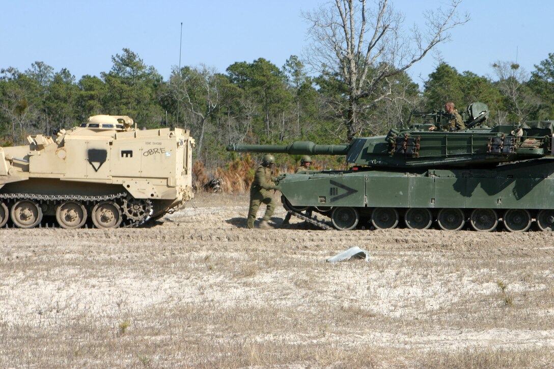 MAIRNE CORPS BASE CAMP LEJEUNE, N.C. (March 10, 2005) ? Two tank operators? finish up with a mock simulation of the Armored Combat Excavator experiencing problems and had to tow it out of the mine field to continue the breaching operation at Engineer Training Area 2 March 10.  The exercise lasted three days and included numerous training evolutions.