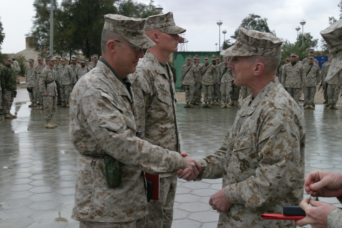 Major General Huck shakes hands with Chief Warrant Officer David R. Dunfee for recieving the Silver Star Award on March 10, 2005.