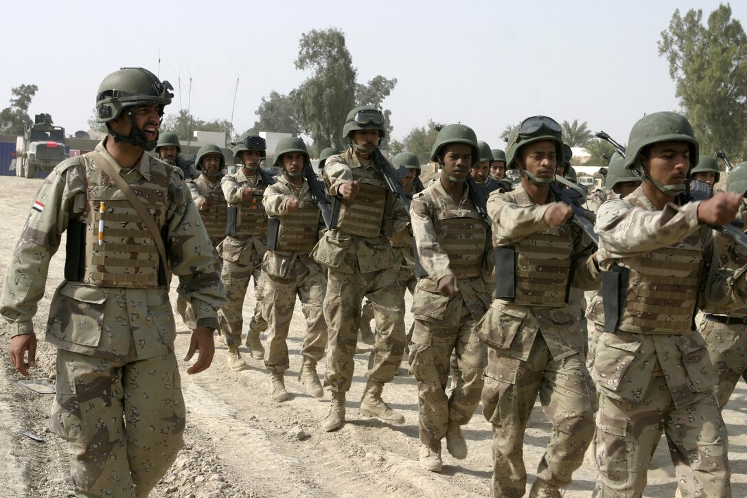 FALLUJAH, Iraq - Sgt. Shaheed Header Raheem, a soldier with the 2nd Battalion, 2nd Brigade, marches his troops around a compound here to teach them basic drill movements.  Iraqi Security Forces personnel are working side-by-side with 1st Battalion, 6th Marine Regiment to conduct a "Lion Training" program to teach new Iraqi army recruits fundamentals of marksmanship, first aid in combat, and military customs and courtesies.