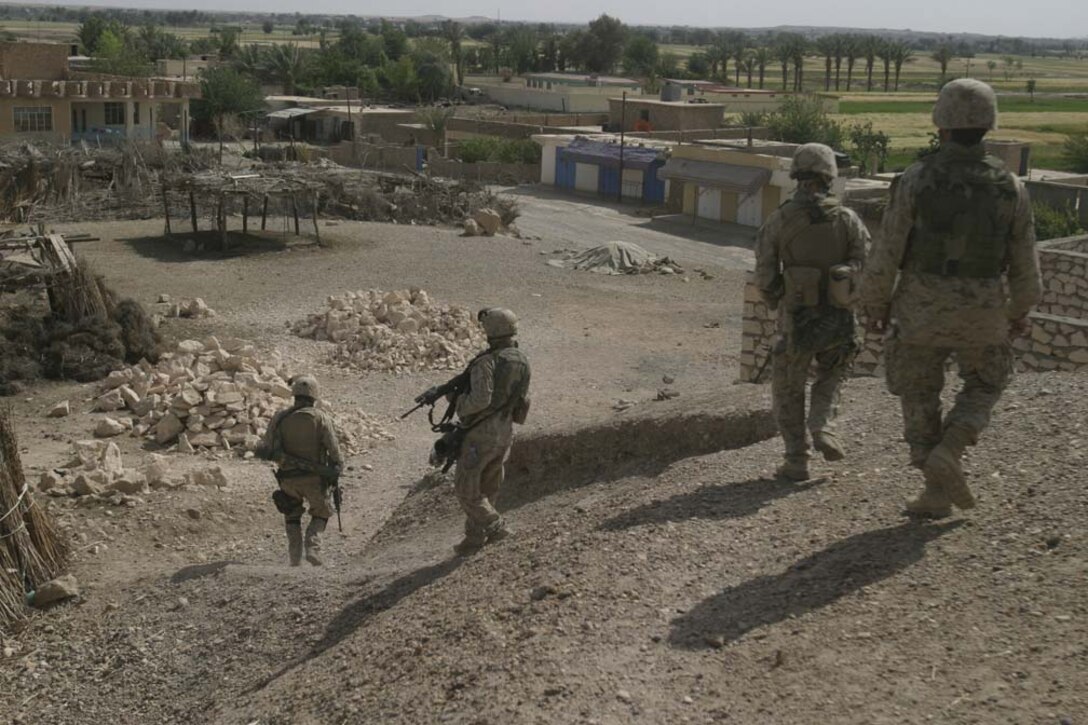 AL UBAYDI, Iraq- Marines from 3d Bn 25th Marines move down a hill towards houses to be searched during a cordon knock May 10, 2005 during Operation Matador. Operation Matador is for disrupting the insurgents known to be a staging area for Syrian and other nationality foreign insurgents. 2D Marine Division is conducting security and stabilization operations in support of Operation Iraqi Freedom III. (OFFICIAL USMC PHOTO BY CPL ERIC C ELY, 2D MARINE DIVISION COMBAT CAMERA)-UNRELEASED