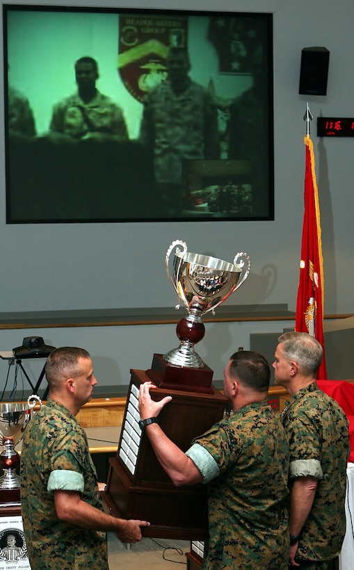 Lt. Col. Donald C. Morse, commanding officer, 2nd Tank Bn., and Sgt. Maj. Roger W. Hoak, sergeant major, 2nd Tank Bn., present the Lt. Gen. Chesty Puller Award trophy to the Marines of B Co., 2nd Tank Bn.  Morse and Hoak lifted the nearly 50-pound trophy so the forward-deployed Marines of Bravo Co. could view it via video teleconference.