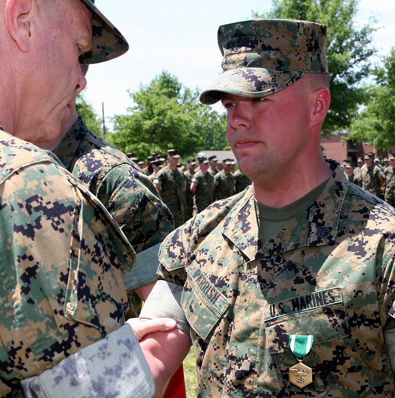 Sgt. Robert L. Parrish, a vehicle operator with Support Co., 2nd Combat Engineer Battalion, 2nd Marine Division, shakes hands with Lt. Gen. James F. Amos, commanding general, II MEF, after being awarded the Navy and Marine Corps Commendation Medal in a ceremony here May 10.  Amos also presented 2nd CEB with the Lt. Gen. Chesty Puller Award for outstanding unit leadership in the same ceremony.