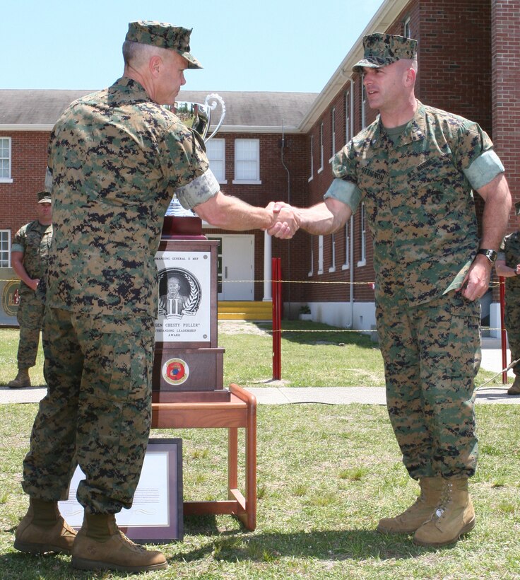 Lt. Col. David A. Ottignon, commanding officer, 2nd Combat Engineer Bn., 2nd Marine Division, is congratulated by Lt. Gen. James F. Amos, commanding general, II MEF, after the battalion won the Lt. Gen. Chesty Puller Award for outstanding leadership.  2nd CEB won in the medium-sized command category, designated for commands with 201 to 800 sailors and Marines.