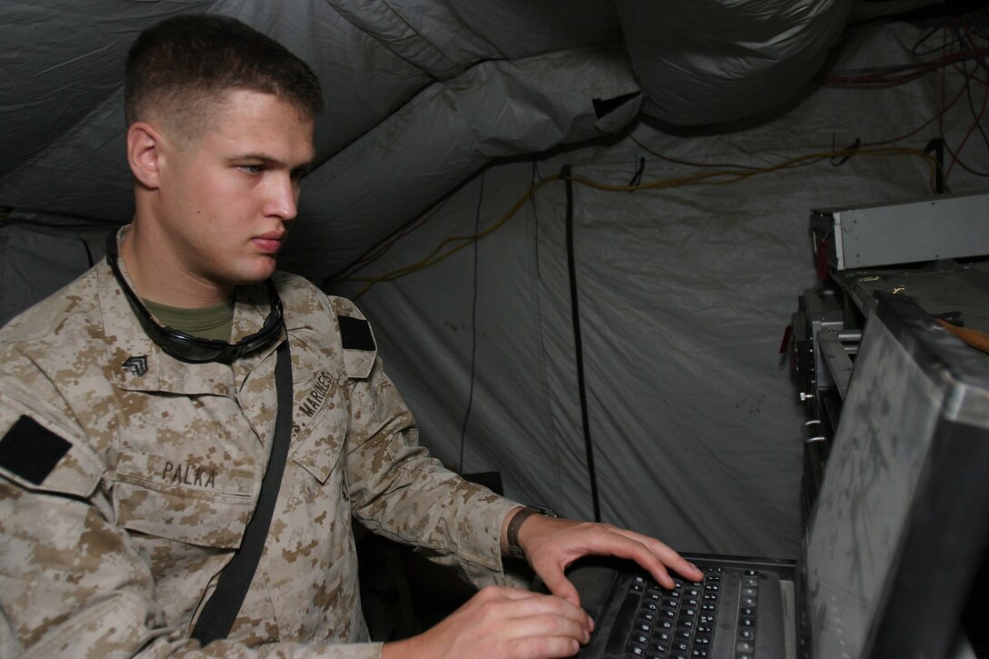 CAMP BLUE DIAMOND, AR RAMADI, Iraq -- Sergeant Keith Palka, a 23-year-old Thomaston, Me. native and data plans chief for the division's communications data section works on the division's network servers.  He and the warrant officer who he works with are the only two Marines in the entire division who control the planning of the wide area computer network across the division's area of responsibility.  U.S. Marine Corps photo by Sgt. Stephen D'Alessio (RELEASED)