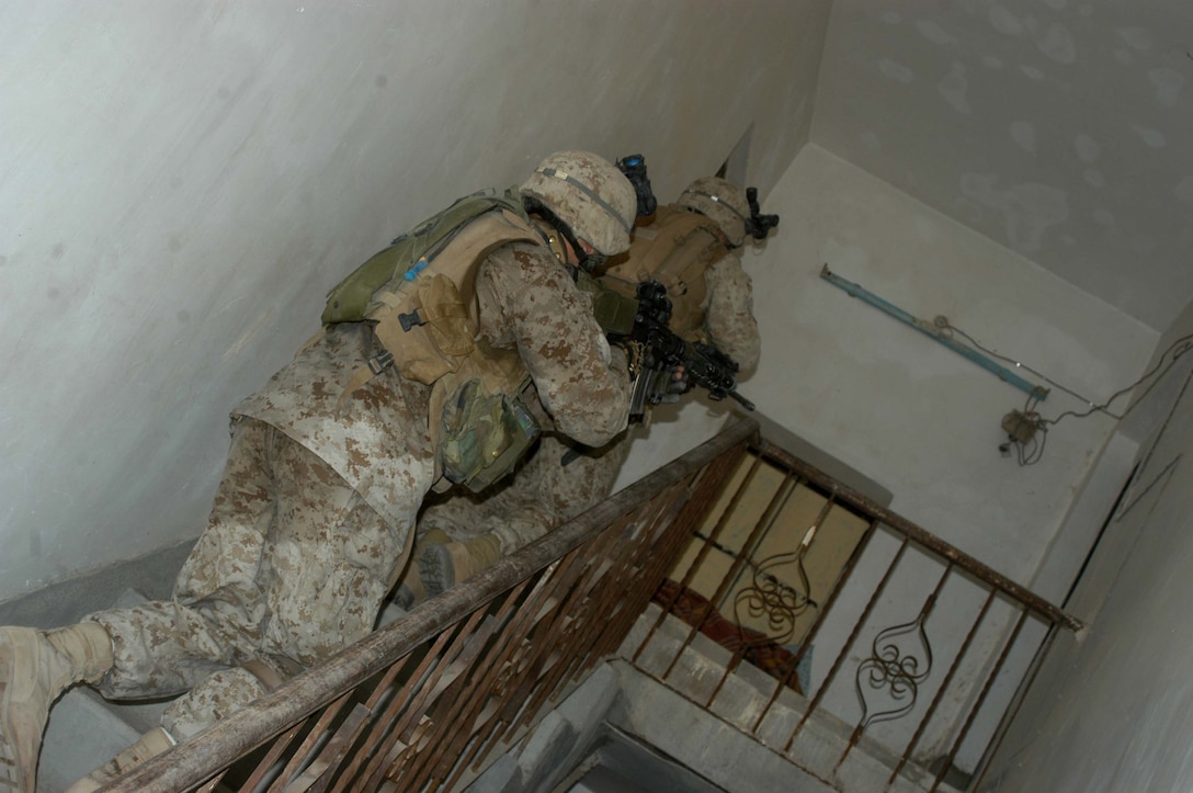 AR RAMADI Iraq (July 10, 2005) -Marines with 4th Platoon, Company W, 1st Battalion, 5th Marine Regiment, quickly climb a flight of stairs while searching a house during a mission in the city here early July 10. Marines with 3rd and 4th Platoon conducted a raid between 1 a.m. and 3 a.m., during which time they captured an insurgent responsible for launching small arms and improvised explosive device(IED) attacks on coalition forces. Photo by: Cpl. Tom Sloan