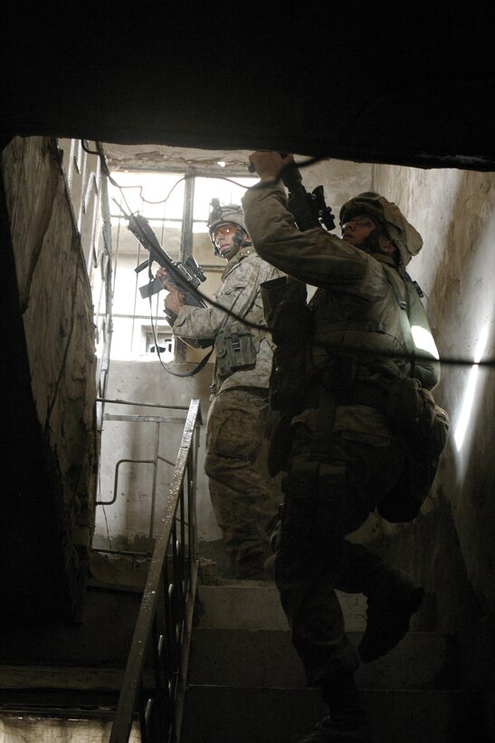 FALLUJAH, Iraq - Marines with 4th Platoon, Company B, 1st Battalion, 6th Marine Regiment search through a house here July 10 during Operation Rolling Barrage.  Company B personnel worked alongside fellow infantrymen, mechanized units and Iraqi Security Forces to block off and search neighborhoods throughout the city for weapons, explosives and insurgent activity.