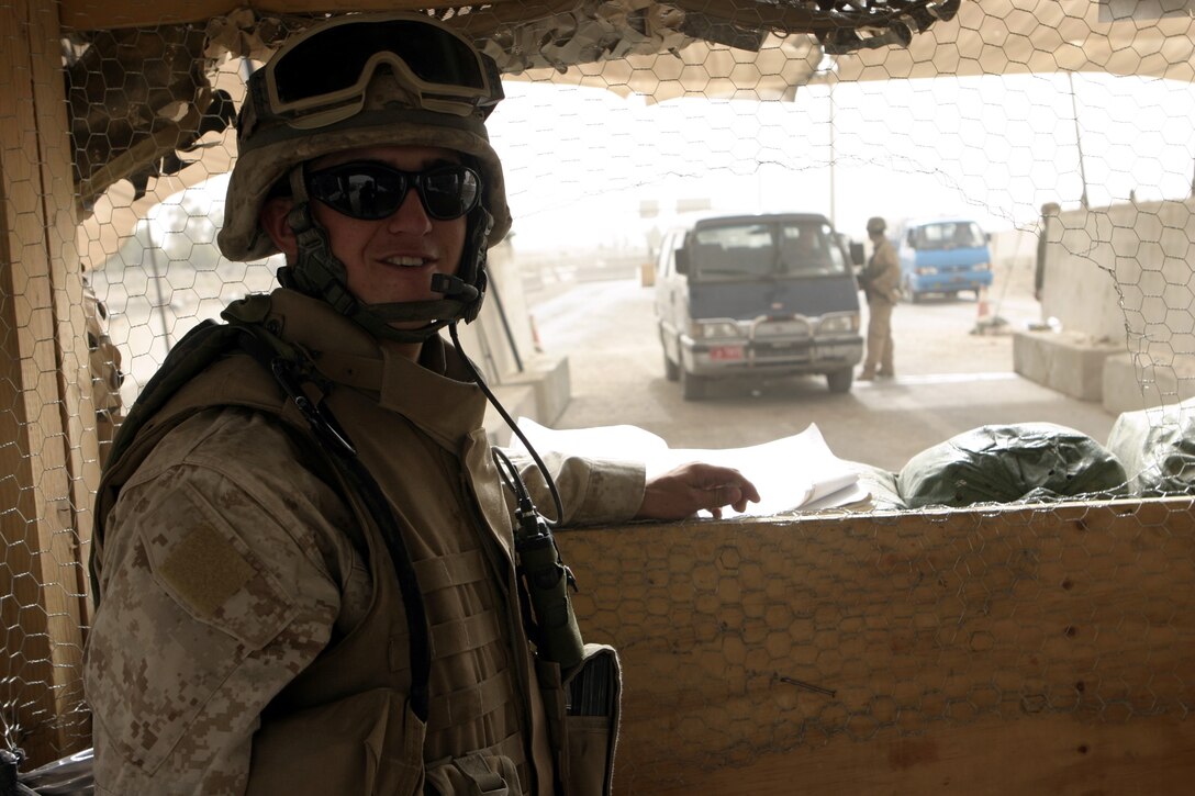FALLUJAH, Iraq - Lance Cpl. Richard Spillers, an infantryman with 1st Battalion, 6th Marine Regiment, takes a break from counting vehicles passing through Entry Control Point-One here Aug. 10.  The 20-year-old Fayetteville, N.C. native and his fellow Marines oversee Iraqi policemen with the Public Order Brigade as they search the thousands of automobiles and local citizens entering the city every day for weapons and contraband.