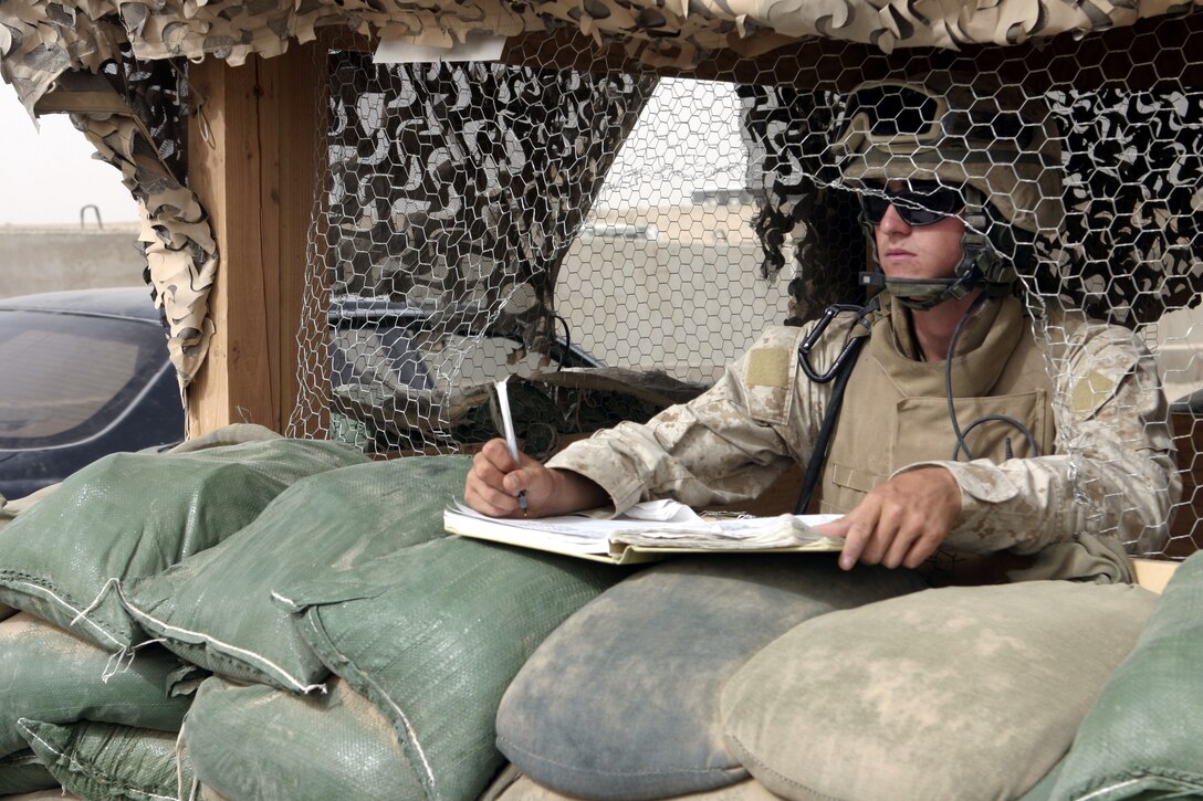 FALLUJAH, Iraq - Lance Cpl. Richard Spillers, an infantryman with 1st Battalion, 6th Marine Regiment, counts vehicles passing through Entry Control Point-One here Aug. 10.  The 20-year-old Fayetteville, N.C. native and his fellow Marines oversee Iraqi policemen with the Public Order Brigade as they search the thousands of automobiles and local citizens entering the city every day for weapons and contraband.