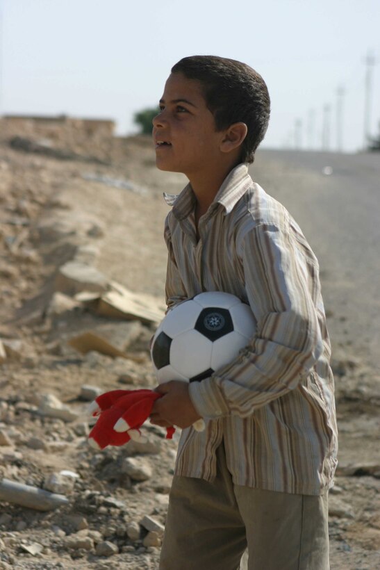 HADITHA, Iraq - An Iraqi child holds a soccer ball and toy received from members of the 6th Civil Affairs Group, Detachment Three, Team Five here Oct. 10. The team operates in the city here to assist the residents by helping to repair buildings and water pipes to improve the lives of the people.