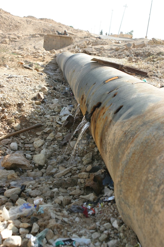 HADITHA, Iraq - A broken water pipe leaks much needed water before local engineers and members of the 6th Civil Affairs Group, Detachment Three, Team Five repair it here Oct. 10. The team operates in the city here to help the residents rebuild their city to improve the lives of the people.