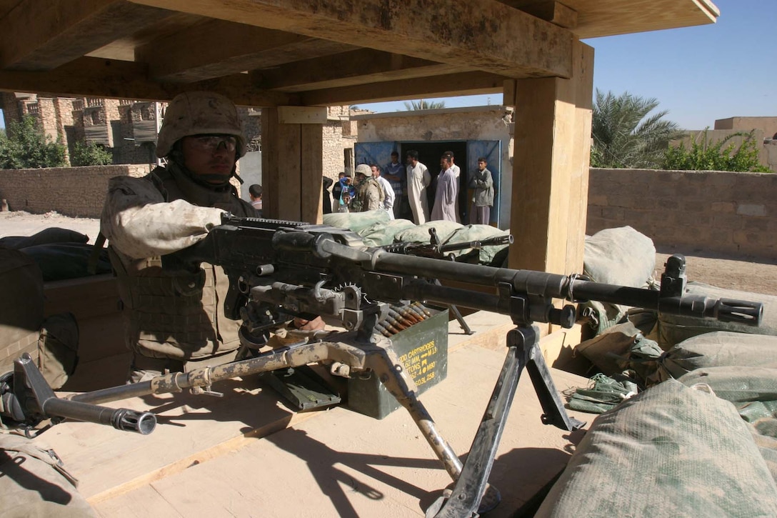 BARWANA, Iraq (Oct. 25, 2005) - Los Angeles native Lance Cpl. Steve Nuno stands post at the entry control point to his company's firm base here Oct. 25. The automatic rifleman for Company L, 3rd Battalion, 1st Marine Regiment, currently spends many hours providing security to keep his fellow Marines safe at their base. (Official Marine Corps photo by Cpl. Adam C. Schnell)