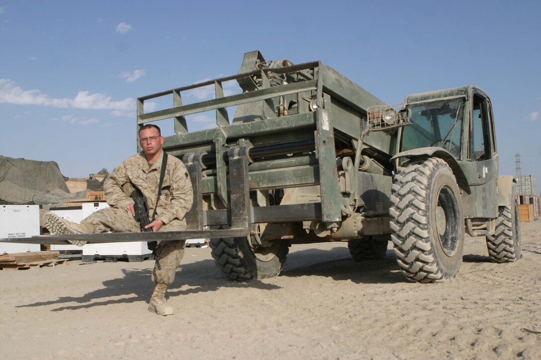 CAMP BLUE DIAMOND, RAMADI, Iraq - Lance Corporal Jesse D. Glennon is a heavy equipment operator, with Combat Service Support Detachment 28 attached to the Camp Lejeune, N.C. based 2nd Marine Division for Operation Iraqi Freedom. Glennon is in the Marine Corps Reserves in Jacksonville, Fl and volunteered for deployment here. Glennon spends the majority of his time loading and offloading the much needed supplies that keep the 2nd Marine Division operational. Official U.S. Marine Corps photo by Sgt. Ryan S. Scranton