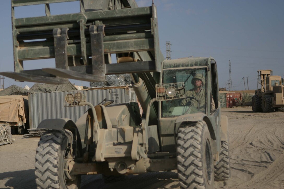 CAMP BLUE DIAMOND, RAMADI, Iraq - Lance Corporal Jesse D. Glennon a heavy equipment operator, with Combat Service Support Detachment 28 attached to the Camp Lejeune, N.C. based 2nd Marine Division drives his Skytrak forklift to load supplies for an upcoming convoy. Glennon is in the Marine Corps Reserves in Jacksonville, Fl and volunteered for deployment here in support of Operation Iraqi Freedom. Glennon spends the majority of his time loading and offloading the much needed supplies that keep the 2nd Marine Division operational. Official U.S. Marine Corps photo by Sgt. Ryan S. Scranton