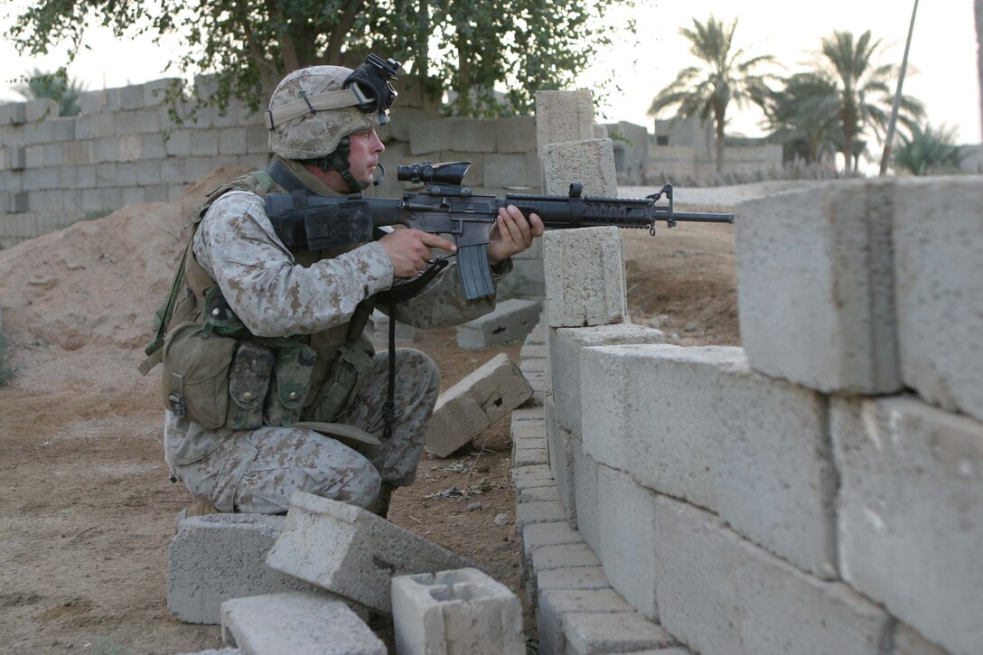 CAMP BLUE DIAMOND, RAMADI, Iraq - - Private Jefferson J. Haney provides security during a patrol through the city here. Jefferson was a artilleryman with Battery L, 3rd Battalion, 10th Marine Regiment before his entire battery was converted into a provisional rifle company to provide security for the 2nd Marine Division's headquarters element. Now, the 25-year-old Fresno, Calif native is a straight-leg infantryman patrolling the streets of Ar Ramadi that surround the camp here. Official U.S. Marine Corps photo by Sgt. Ryan S. Scranton