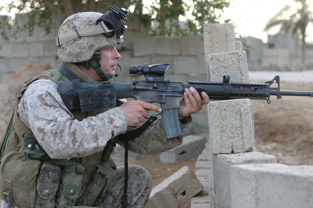 CAMP BLUE DIAMOND, RAMADI, Iraq - - Private Jefferson J. Haney provides security during a patrol through the city here. Jefferson was a artilleryman with Battery L, 3rd Battalion, 10th Marine Regiment before his entire battery was converted into a provisional rifle company to provide security for the 2nd Marine Division's headquarters element. Now, the 25-year-old Fresno, Calif native is a straight-leg infantryman patrolling the streets of Ar Ramadi that surround the camp here. Official U.S. Marine Corps photo by Sgt. Ryan S. Scranton