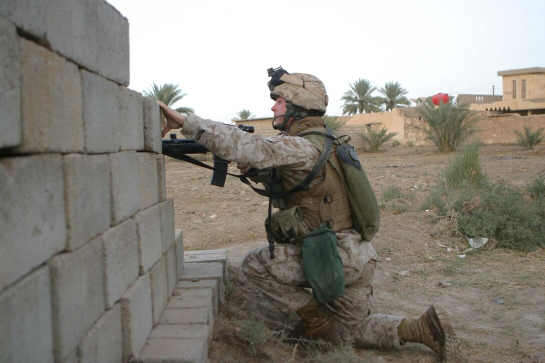 CAMP BLUE DIAMOND, RAMADI, Iraq - - Private Jefferson J. Haney provides security during a patrol through the city here. Jefferson was a artilleryman with Battery L, 3rd Battalion, 10th Marine Regiment before his entire battery was converted into a provisional rifle company to provide security for the 2nd Marine Division's headquarters element. Now, the 25-year-old Fresno, Calif native is a straight-leg infantryman patrolling the streets of Ar Ramadi that surround the camp here. Official U.S. Marine Corps photo by Sgt. Ryan S. Scranton