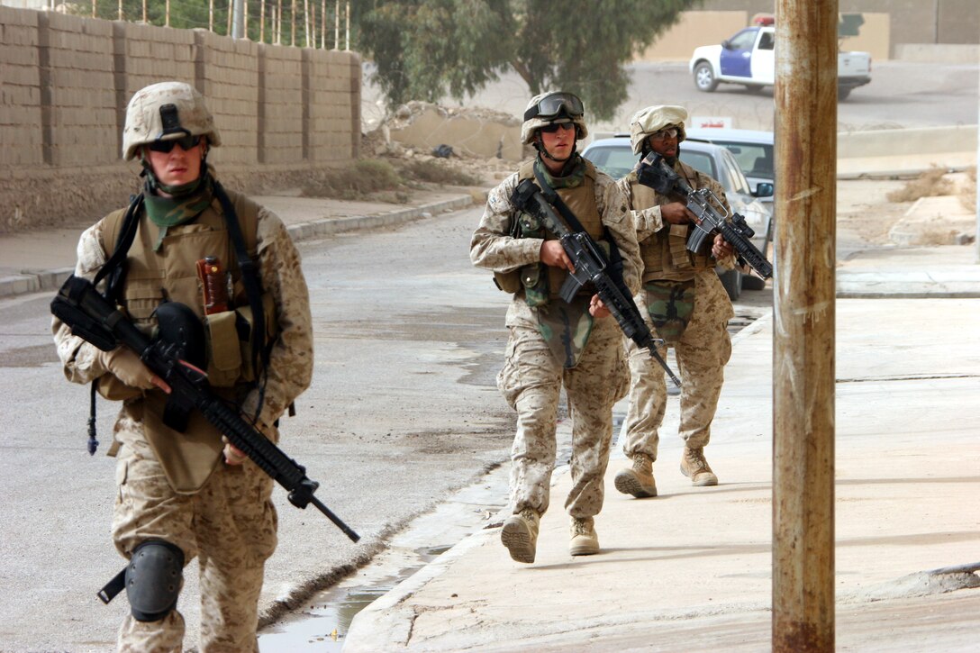AR RAMADI, Iraq (November 5, 2005) - Three Marines from 3rd Battalion, 7th Marines and 6th Civil Affairs Group patrol through the streets of Ar Ramadi Nov. 5. Photo by Cpl. Shane Suzuki