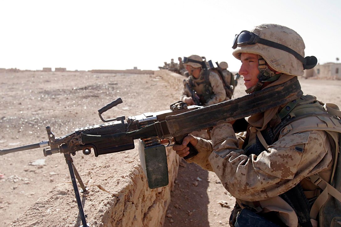 Husaybah, Iraq ( November 10, 2005)-- A scout with 2nd platoon, 1st LAR prepares to cross an open area with the rest of his section a door while on patrol during Operation Steel Curtain on the Marine Corps' 230th Birthday. The Marines found a cache and were given a hot meal at the end of day in celebration of the holiday. (Official U. S. Marine Corps photo by Corporal Ken Melton)