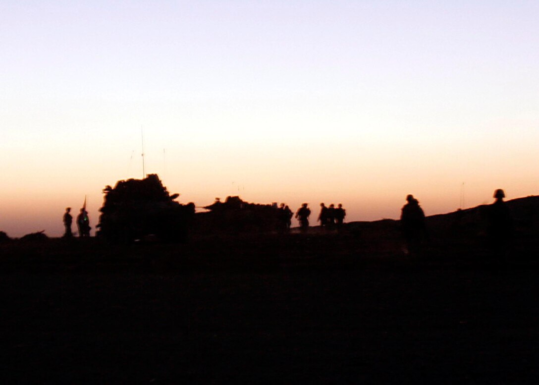 Husaybah, Iraq ( November 10, 2005)--Scouts with 2nd platoon, 1st LAR return after a patrolling during Operation Steel Curtain on the Marine Corps' 230th Birthday. The Marines found a cache and were given a hot meal at the end of day in celebration of the holiday. (Official U. S. Marine Corps photo by Corporal Ken Melton)