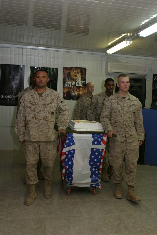 CAMP BLUE DIAMOND, RAMADI, Iraq - Marines with Headquarters Battalion, 2d Marine Division escort the birthday cake during the battalion's Marine Corps Birthday ceremony here Nov. 10. Official U.S. Marine Corps photo by Sgt. Ryan S. Scranton