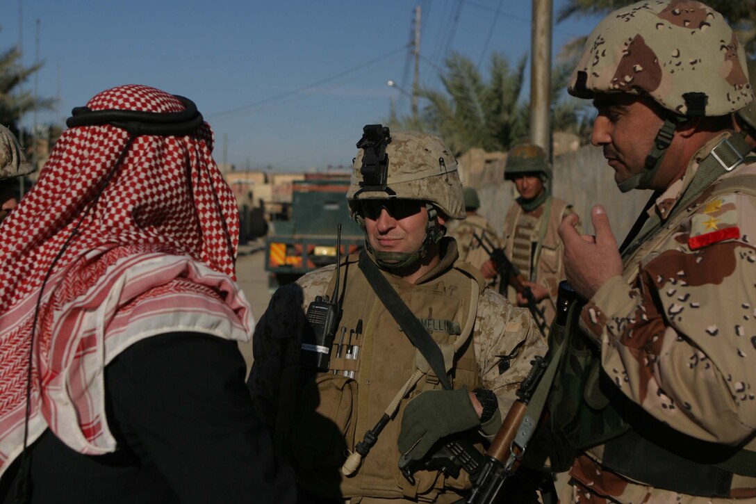 CAMP DEFENDER, RAMADI, Iraq - Major John Armellino the Military Transition Team battalion commander for 1st Battalion, 1st Brigade of the 7th Iraqi Army Division talks with a local citizen in Rhamadi during Operation Lions here. Operation Lions was a major milestone for 1-1-7 who operated independent from U.S. military support. Official U.S. Marine Corps photo by Sgt. Ryan S. Scranton