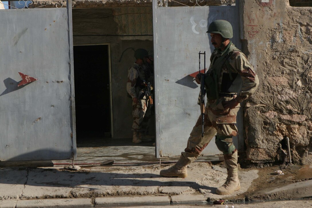 CAMP DEFENDER, RAMADI, Iraq - An Iraqi soldier with 1st Battalion, 1st Brigade of the 7th Iraqi Army Division provides security while his fellow soldiers search a home during Operation Lions here. Operation Lions was a major milestone for 1-1-7 who operated independent from U.S. military support. Official U.S. Marine Corps photo by Sgt. Ryan S. Scranton