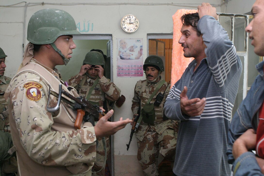 CAMP DEFENDER, RAMADI, Iraq -  An Iraqi soldier with 1st Battalion, 1st Brigade of the 7th Iraqi Army Division questions a man inside his home during Operation Lions. Operation Lions was a major milestone for 1-1-7 who operated independent from U.S. military support. Official U.S. Marine Corps photo by Sgt. Ryan S. Scranton