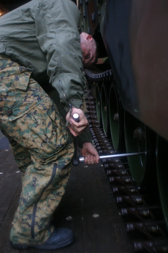 MARINE CORPS BASE CAMP LEJEUNE, N.C. (Jan. 10, 2005)- A Marine with Company B, 2nd Amphibious Assault Battalion, 2nd Marine Division works on his track aboard the USS Whidbey Island off the coast of North Carolina during ship operation training here. The AAV Marines got a chance to get back into the water after a heavy rotation to the desert-urban areas of Iraq.