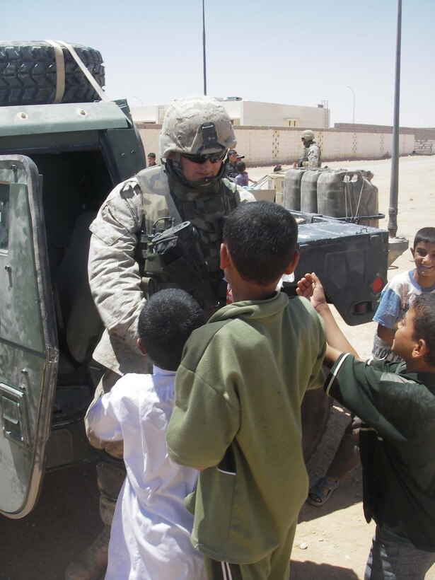 Cpl. Morgan J. Hendrickson, driver/civil affairs assistant, 5th Civil Affairs Group (CAG), 2d Light Armored Reconnaissance Battalion, Regimental Combat Team-2,  and the other members of CAG work on supplying some of the towns in western Iraq with water, building hospitals, improving schools and helping to rebuild other vital parts of the cities. (Photo by Cpl. Freddy Medina)