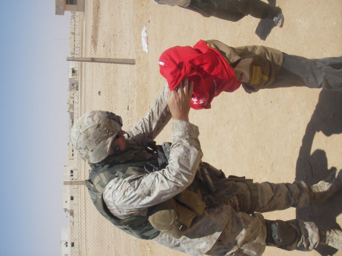 Cpl. Morgan J. Hendrickson, driver/civil affairs assistant, 5th Civil Affairs Group (CAG), 2d Light Armored Reconnaissance Battalion, Regimental Combat Team-2,  and the other members of CAG work on supplying some of the towns in western Iraq with water, building hospitals, improving schools and helping to rebuild other vital parts of the cities. (Photo by Cpl. Freddy Medina)