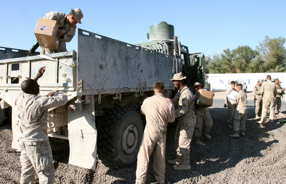 Marines from Headquarters and Service Company, 2nd Battalion, 7th Marine Regiment, 2nd Marine Division, unload a 7-ton truck filled with mail here Dec. 10. Many organizations, such as Packages from Home, send care packages to deployed military personnel to help them cope with the strain that comes along with being separated from their loved ones.
