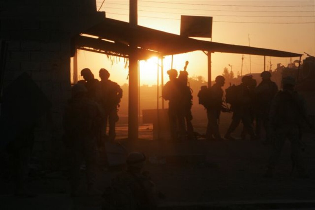 KARABILAH, Iraq ? Marines are shown clearing garages here during the early morning hours of Nov 10. Earlier, the Marines assigned to 3rd Platoon, Company E, 2nd Battalion, 1st Marine Regiment, paused at a vacant house to reflect on the 230th Birthday of the U.S. Marine Corps.