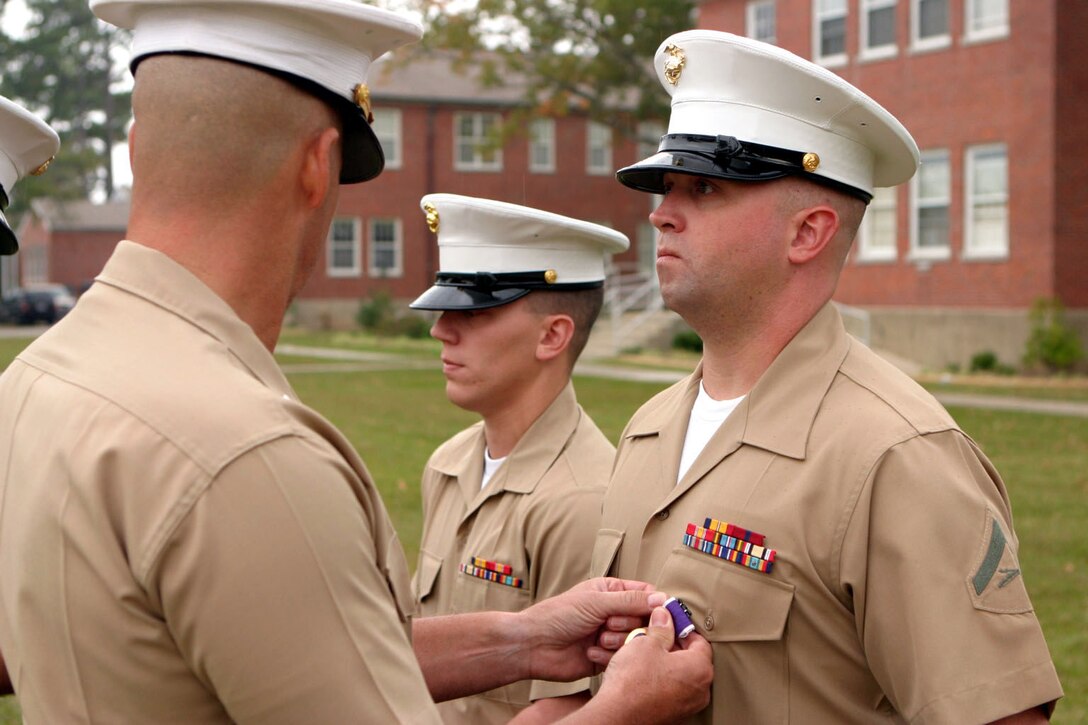 MARINE CORPS BASE CAMP LEJEUNE, N.C. -- Lance Cpl. John T. Shepard, a boat mechanic formerly with Small Craft Company, Headquarters Battalion, 2nd Marine Division, is presented his Purple Heart Medal here Nov. 10.  The 31-year-old Athens, Ga. native was wounded in August in Ramadi, Iraq, when numerous insurgents ambushed members of his unit as they were patrolling the city streets.